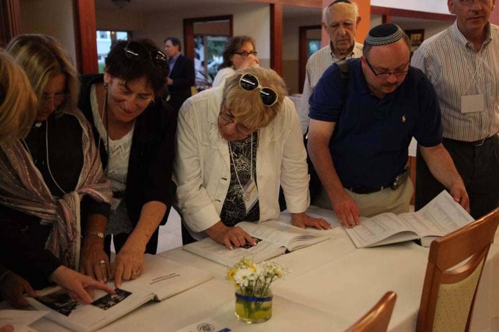 Participants view the Memorial Book of Jewish Bardejov