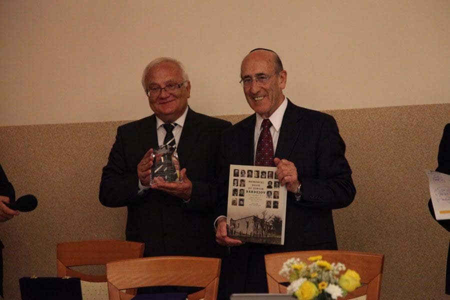 Mr. Hanuscak, Mayor of Bardejov, receives his award and the Memorial Book of Jewish Bardejov