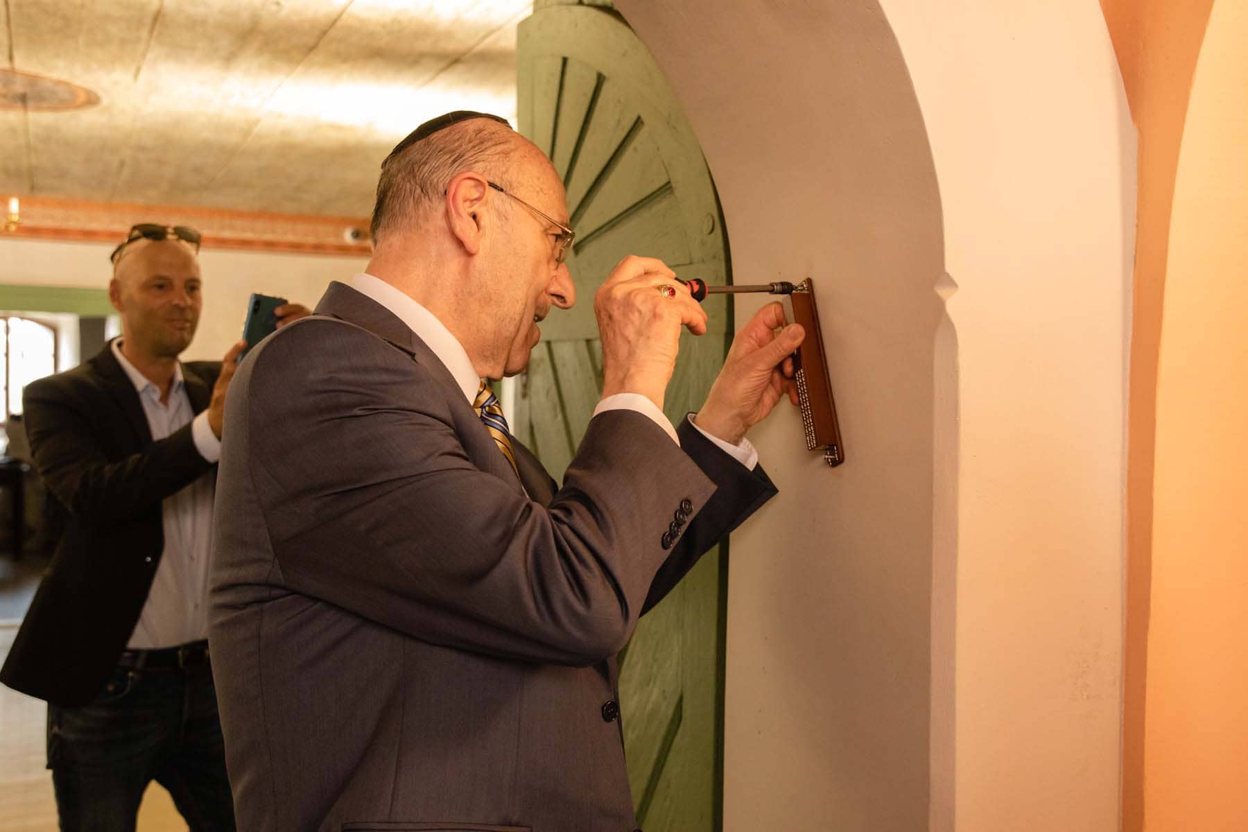 Mr. Emil Fish, together with Mr. Paul Packer and representatives of Jewish religious communities in Slovakia, attached a mezuzah to the doorpost of the entrance door