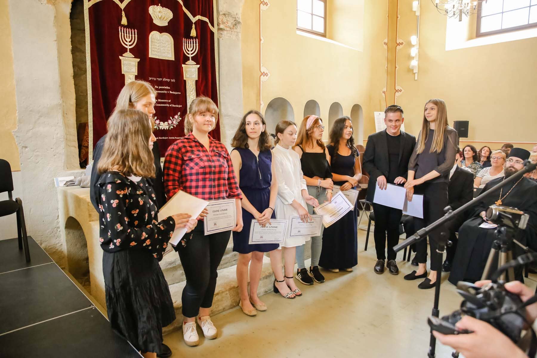 Participants of the Art Contest stand on stage with their certificates