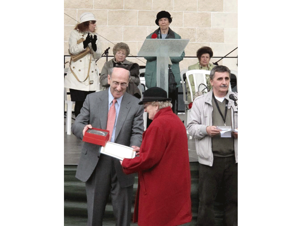 Mr. Fish gives the 'Righteous of Bardejov' award to the daughter of Adam Bomba who risked his life to save Bardejov Jews