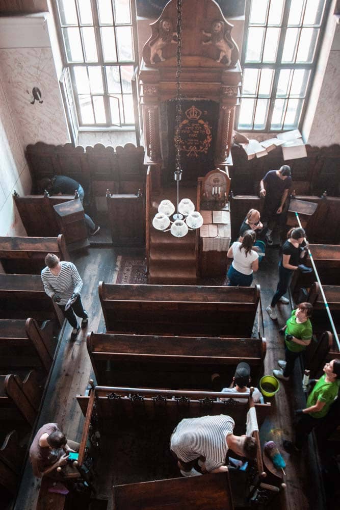The students split up to tackle cleaning different areas of the synagogue at the same time